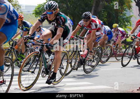 Cyclists in the peloton ride into the corner, Tour de Taiwan stage 1 crtierium, Kaohsiung, Taiwan, ROC Stock Photo