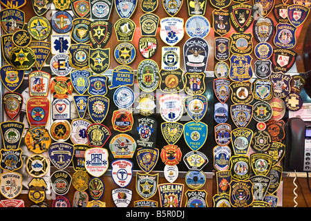 Police and emergency services badges on a wall Stock Photo