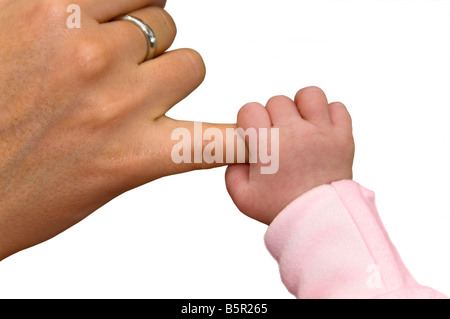 Horizontal studio close up of a newborn baby's hand holding onto a woman's little finger against a white background