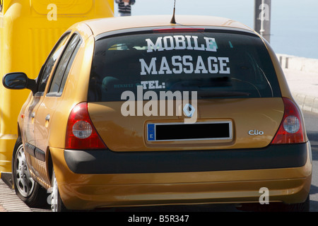 Car with mobile massage sign on window. I  have blanked out telephone number and car registration Stock Photo