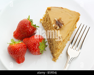 Walnut cake with strawberries and fork high key Stock Photo