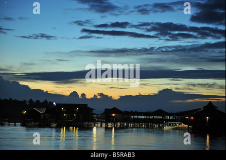 Dusk over Sipadan Water Village, Mabul Island showing water bungalows in sunset. Stock Photo