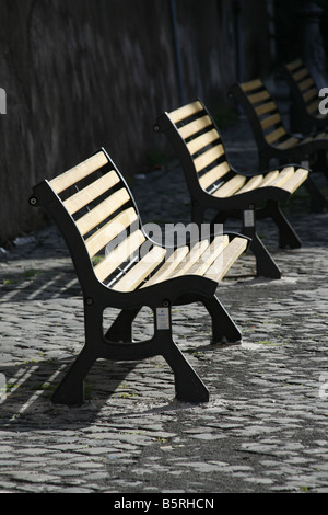 detail of empty wooden park benches on street Stock Photo