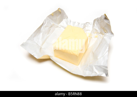 Slab of butter and foil wrapper isolated on a white studio background Stock Photo