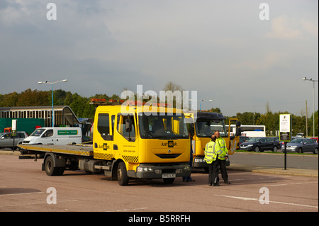 AA patrol vehicle swapping car from one vehicle to another AA van on M4 motorway service station. Stock Photo