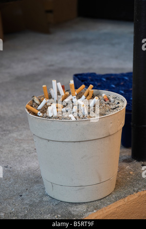 cigarette sand buckets cigarette stubs in sand Stock Photo