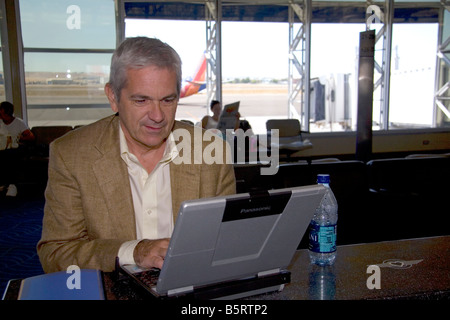 Man using a laptop computer in the Boise Airport Boise Idaho Stock Photo