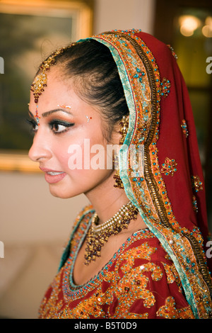 Sikh woman getting ready for her traditional marriage ceremony in temple or gurdwara uk Stock Photo