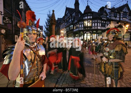 City of Chester, England. Roman Tours conducting a torchlight Christmas parade Saturnalia re-enactment event in the city centre. Stock Photo