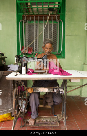 Man with a sewing machine in Pondicherry India Stock Photo