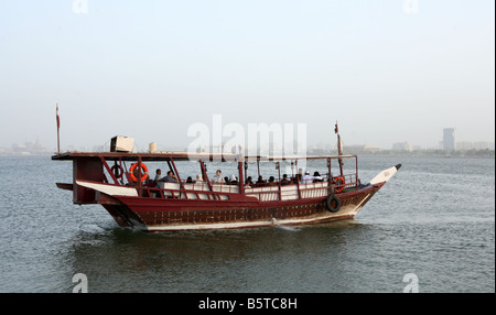 A traditional dhow takes families on a trip around Doha Bay Qatar during the Eid al Fitr holiday October 2 2008 Stock Photo