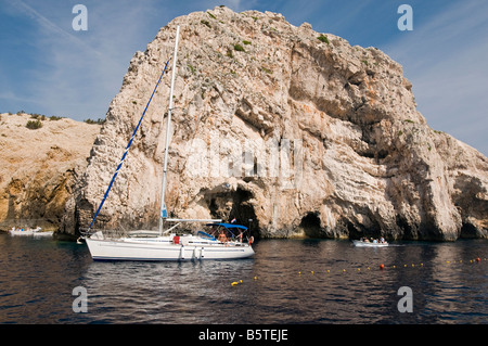 Sailing boats in front of the famous Blue Cave in Bisevo Island, Croatia Stock Photo