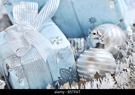 Wrapped gift boxes with silver Christmas ornaments Stock Photo
