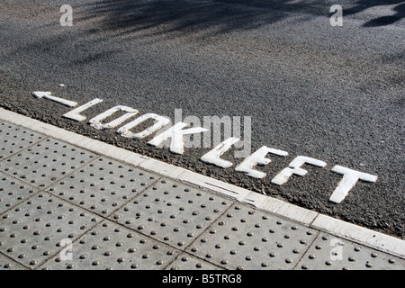 Look Left sign painted on road at crossing Stock Photo