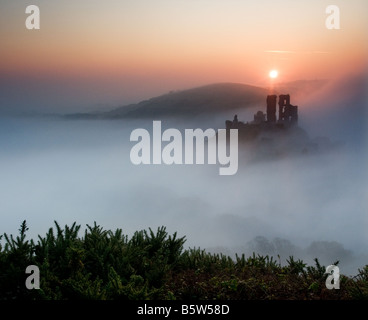 Corfe Castle shrouded in early morning mist Purbeck Dorset South West England UK Castle Stock Photo