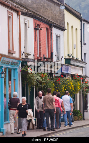 People walking past row of shops in small market town UK Stock Photo