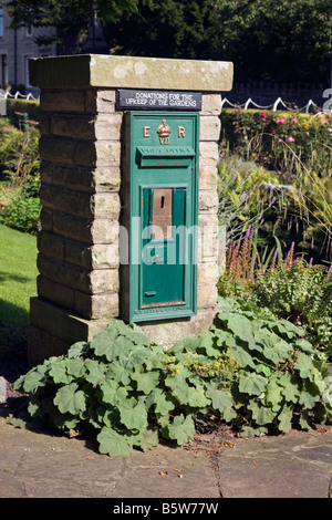 Green post box used as collection box in Coronation Gardens in the Village of Waddington Lancashire Stock Photo