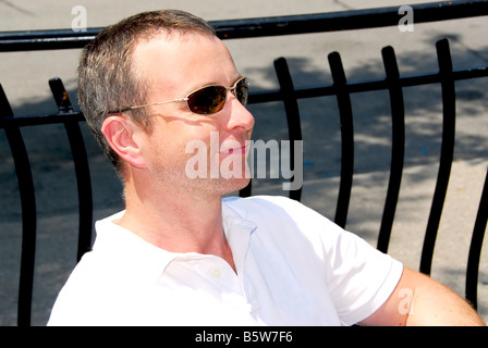 Portrait of a smiling man wearing sunglasses in outdoor cafe Stock Photo