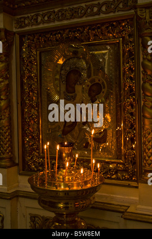 Burning candles in front of icon of Our Lady in Trinity Cathedral in Pskov (Russia) Stock Photo