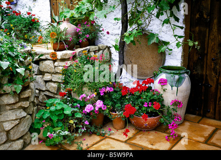 Mediterranean Patio with colourful flower filled containers Stock Photo