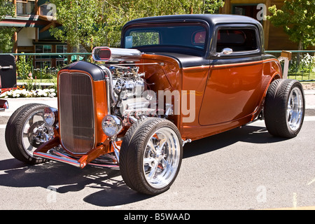 Bronze and black Ford type open wheel hot rod with a supercharged V8 engine Stock Photo