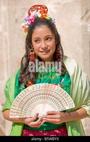 San Antonio Founders Day, young Hispanic woman in traditional dress in San Fernando Cathedral Square Stock Photo