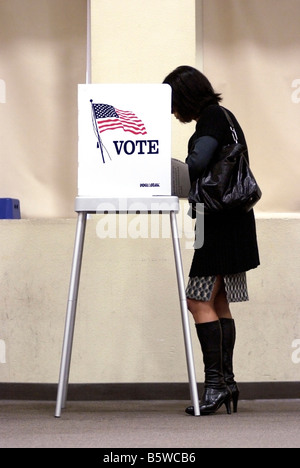 Young woman marking her ballot at Polling Place in San Jose, CA, on November 4, during the 2008 U.S. Presidential election. Stock Photo