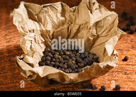 Black peppercorns in a paper Stock Photo