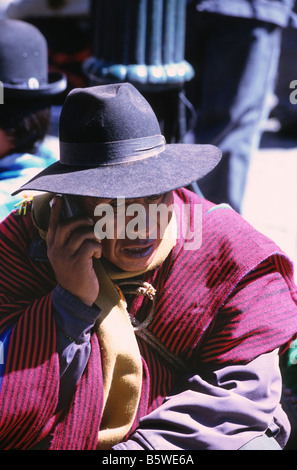 Indigenous Aymara leader speaking on mobile phone during demonstration, La Paz , Bolivia Stock Photo