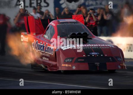 The "Quick Lane" NHRA funny car of Robert Tasca III accelerates off the