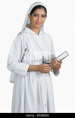 Portrait of a nun holding the Bible Stock Photo