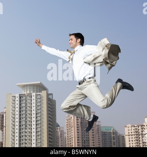 Businessman flying with his arms outstretched Stock Photo