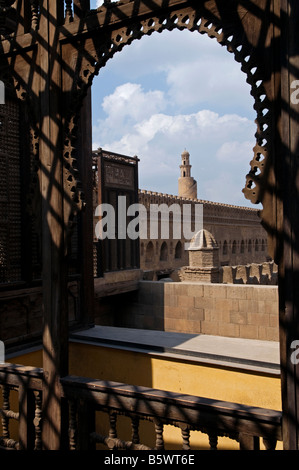 View of Ibn Tulun mosque through carved wood latticework Mashrabiya window at the Egyptian roof terrace of the Gayer-Anderson Museum in Cairo Egypt Stock Photo