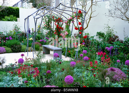 Red and Purple flowering walled garden at Chelsea Stock Photo