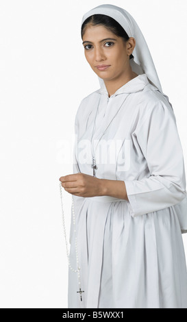 Portrait of a nun holding rosary beads Stock Photo