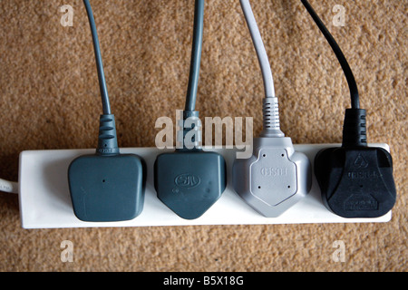 Electric power plugs in a four way adapter Stock Photo