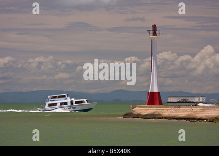 BELIZE CITY BELIZE Tour boat passes Fort George lighthouse on way into Belize Harbor Stock Photo