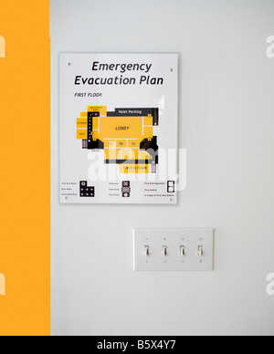 evacuation route map sign mounted on wall Stock Photo