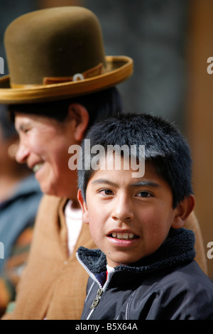 Woman in traditional dress in La Paz Bolivia with smiling boy Stock Photo