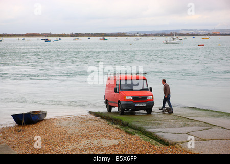 Recovering a dinghy on the slipway at Hayling Island Stock Photo