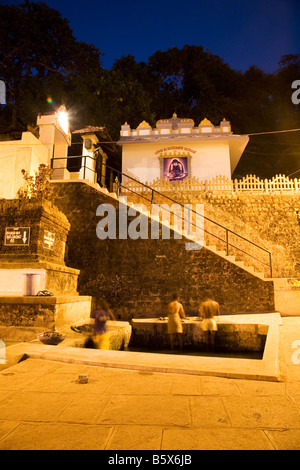 People take an evening bath at the Kadri Manjunatha Temple in Mangalore, India. Stock Photo