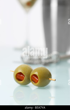 Olives with martini shaker and bartending tools in background Stock Photo