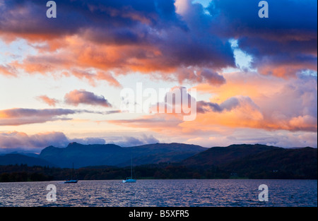 Sunset over Windermere in the Lake District Cumbria England UK with the Langdale Pikes in the distance. Stock Photo