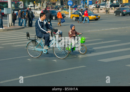 Father and son on a bike in Beijing China Stock Photo