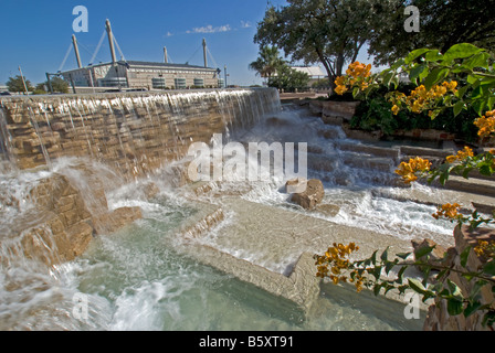 San Antonio's HemisFair Park, water fall fountain with Alamodome in upper left background Stock Photo