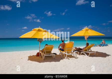 Chairs and umbellas on Shoal Bay East Beach on the caribbean island of Anguilla in the British West Indies Stock Photo