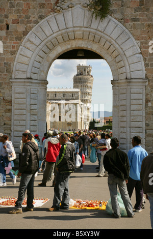 Street hawkers selling souvenirs at the entrance to the Campo Dei Miracoli and Leaning Tower of Pisa, Italy. Stock Photo