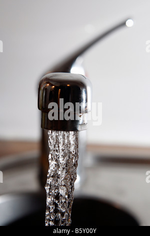 Water gushing from a domestic tap fawcet Stock Photo