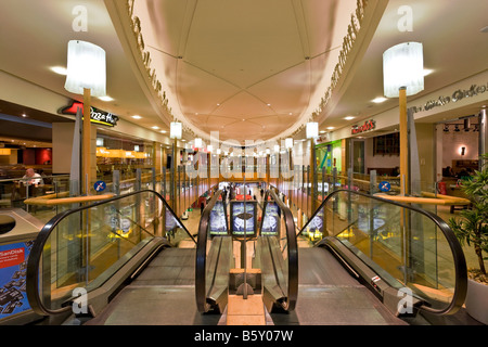 The escalators. A modern interior of the supermarket with escalator ...