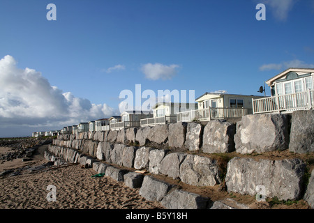 Stone breakwater and caravans at Newton Beach Porthcawl Mid Glamorgan South Wales Stock Photo